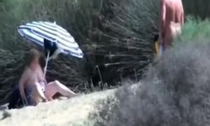 Pervert granny masturbates in front of stranger at beach