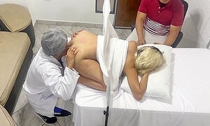 Pervert Poses As A Gynecologist Doctor To Fuck The Beautiful Wife Next To Her Dumb Husband In An Erotic Medical Consultation