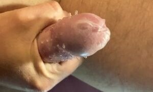 Masturbation of a cock in a rubber condom.